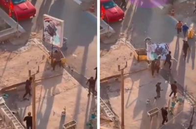 عراقيون يسقطون ويمزقون صورة الإرهابي الإيراني " قاسم سليماني" وسط ⁧‫بغداد‬⁩ • صحيفة المرصد